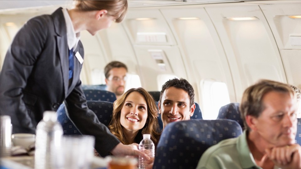 Flight attendant helping customers